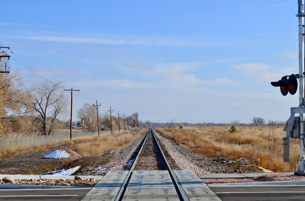 black train rail under blue sky during daytime