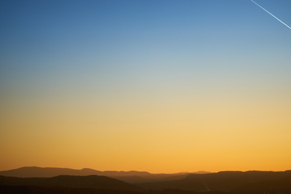 silhouette of mountain during sunset