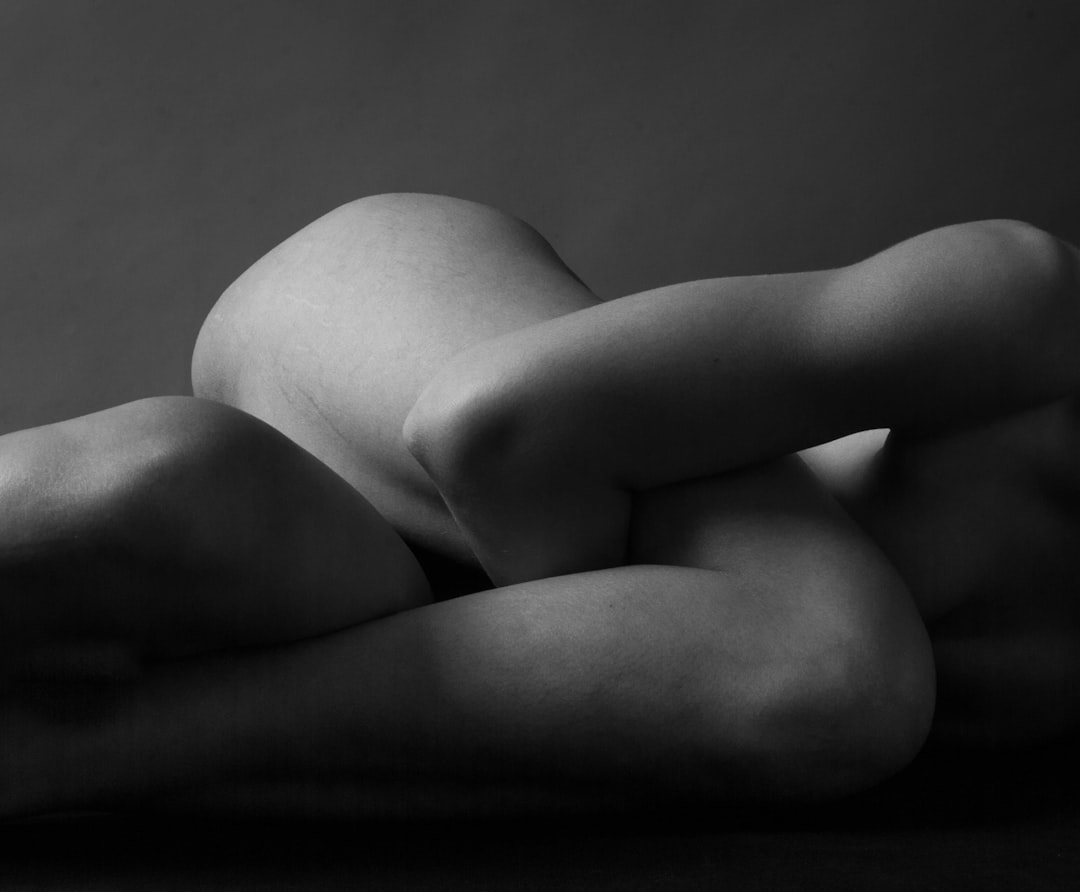 naked woman lying on bed,