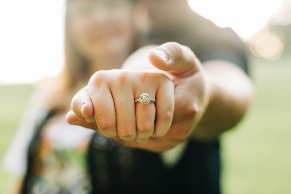 person wearing gold wedding band