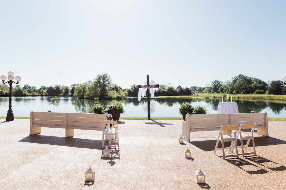 brown wooden picnic table near body of water during daytime