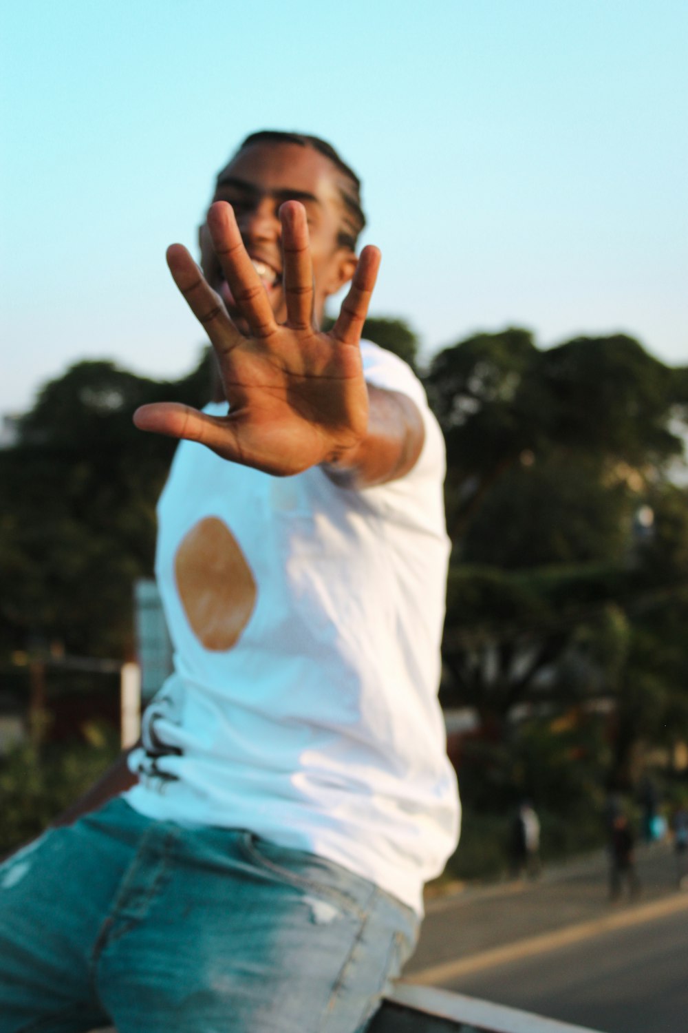 man in white crew neck t-shirt and blue shorts