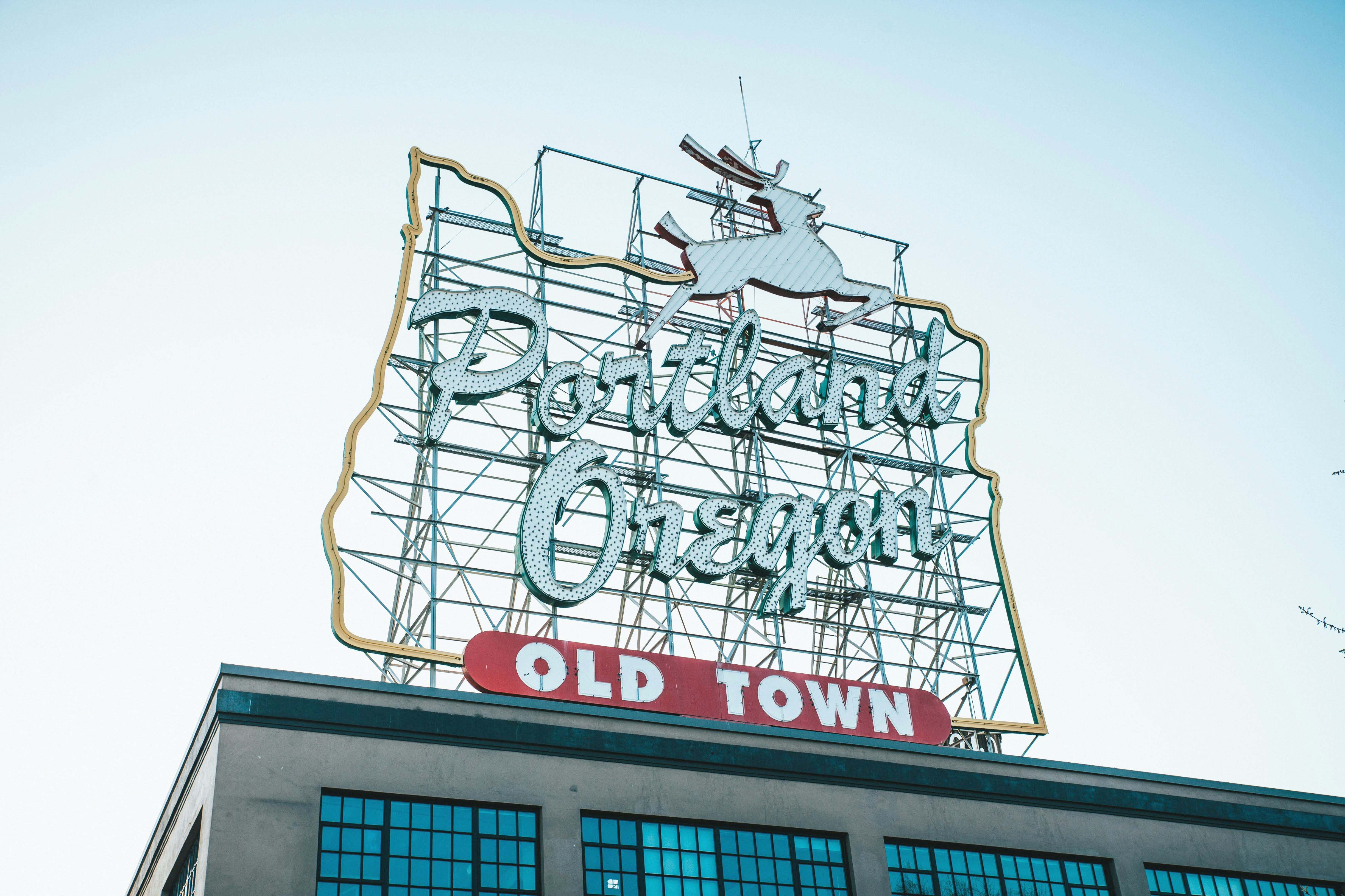 an old town sign on top of a building