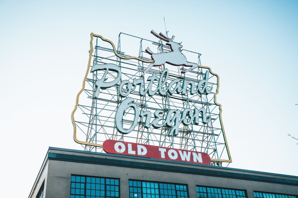 an old town sign on top of a building