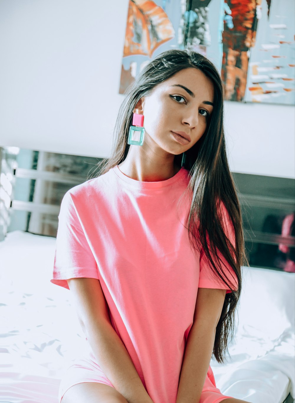 woman in pink crew neck t-shirt standing on white sand during daytime