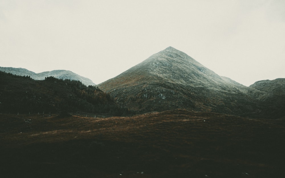 green and brown mountain under white sky during daytime