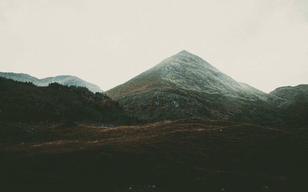 green and brown mountain under white sky during daytime