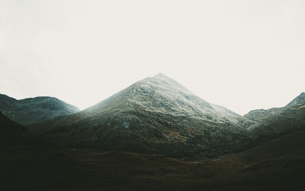 gray and green mountain under white sky during daytime