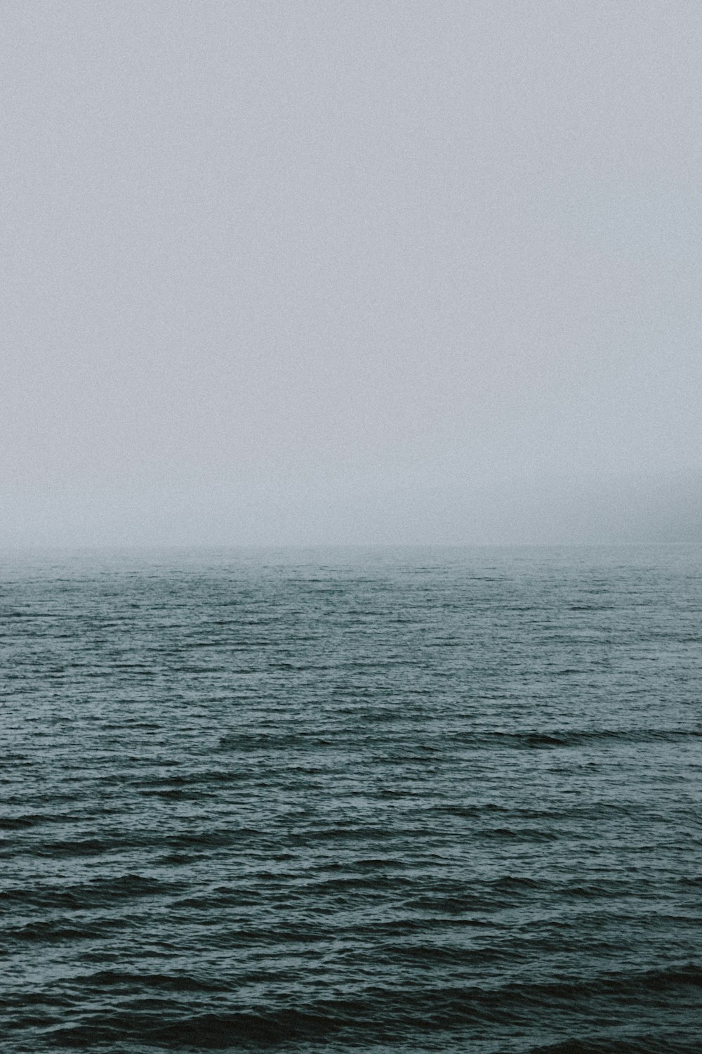 body of water under gray sky