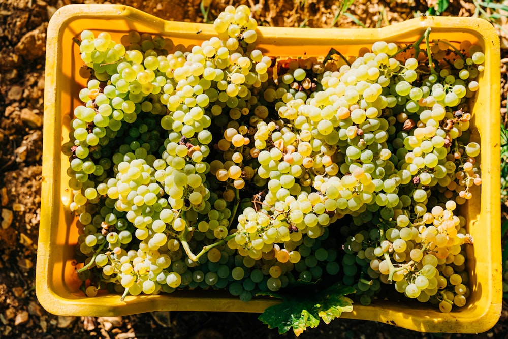 white grapes on brown wooden crate