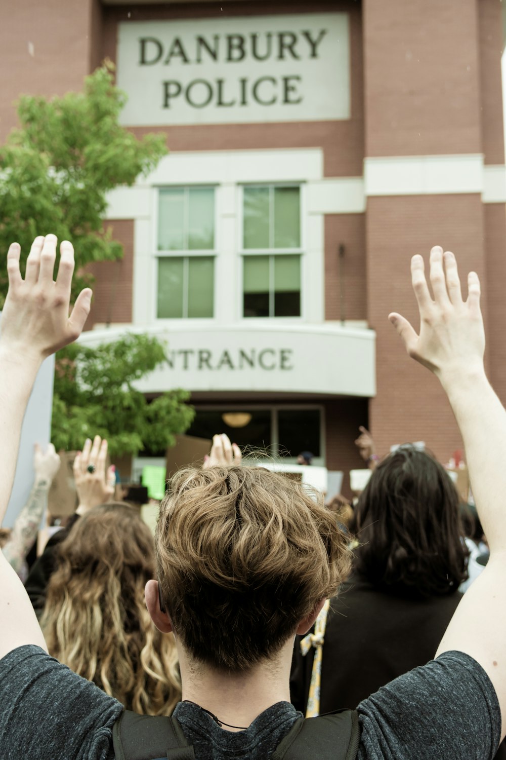 people in front of brown building during daytime