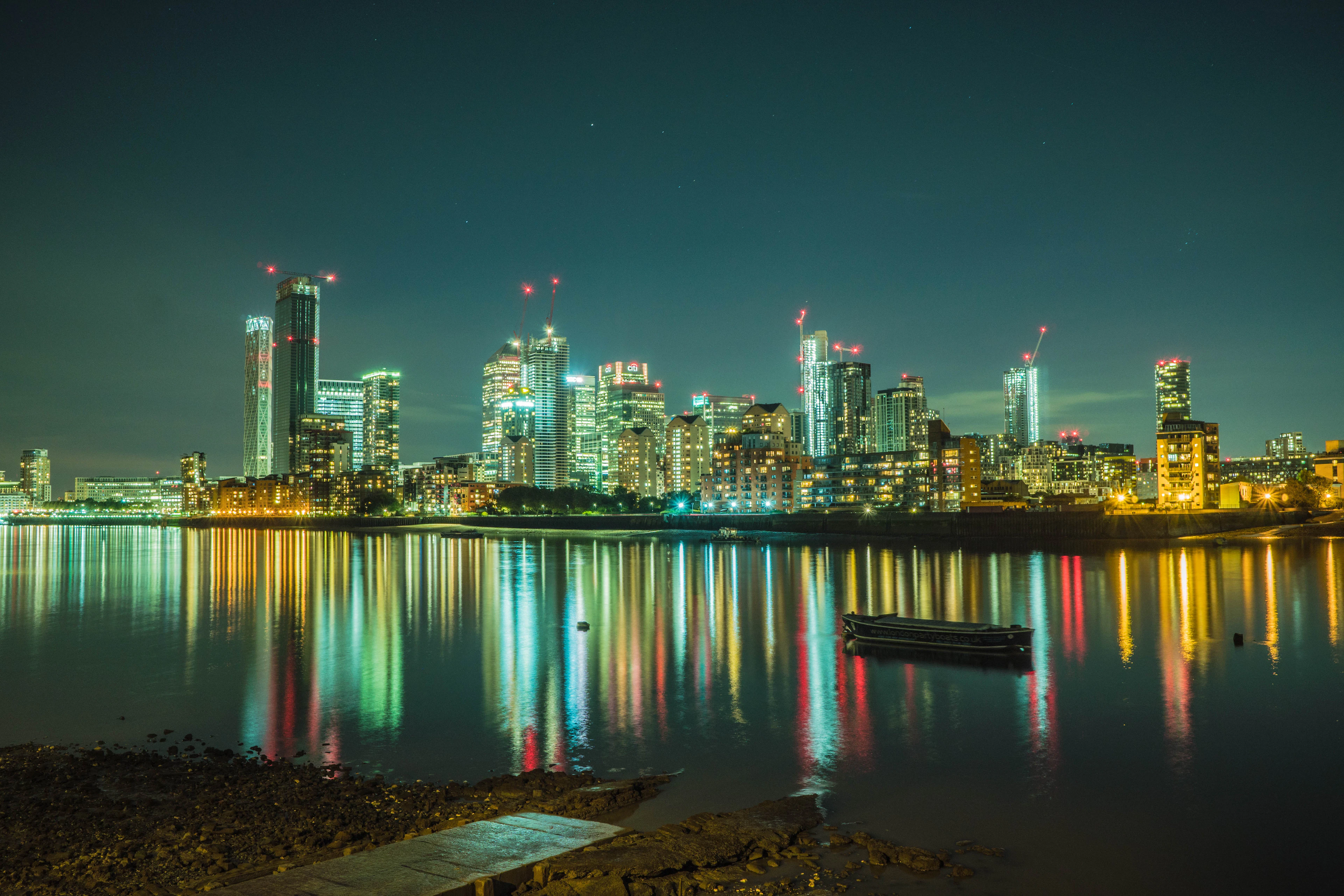 The Canary Wharf skyline reflected in the Thames at night