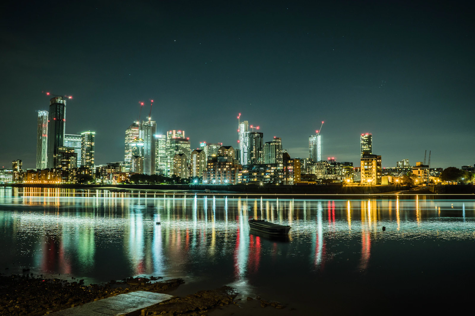 Canary Wharf financial district in London at night, where UK digital PR link prices run higher than US averages