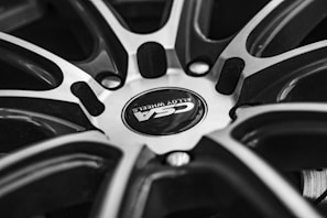 Before and after comparison of a car rim showing the transformation after CNC machining.