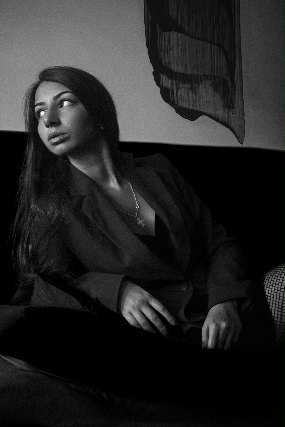 woman in black coat sitting on sofa