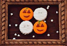 white and orange round ornament on brown wooden table