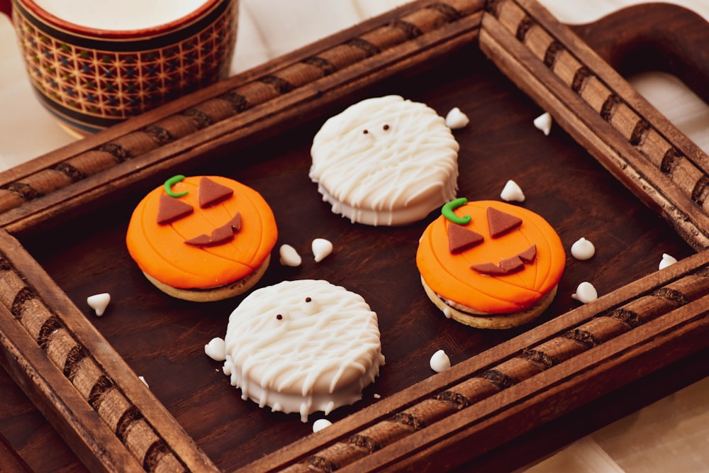 white and brown cupcakes on brown wooden tray