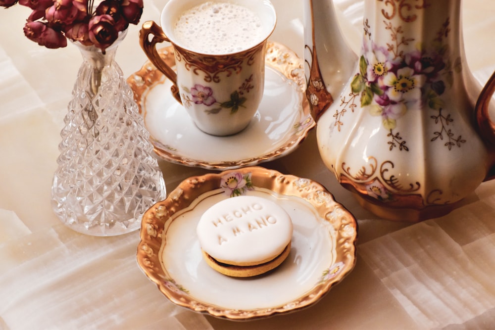 white and blue ceramic teacup on saucer