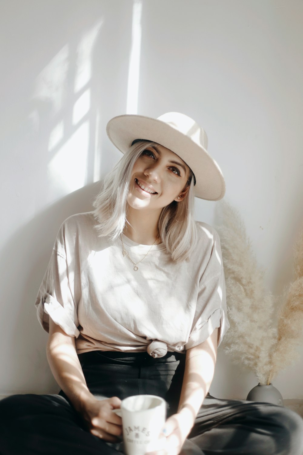 woman in white shirt wearing white hat