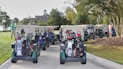 people riding on blue and white golf cart during daytime