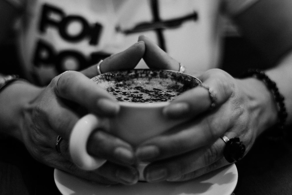 person holding white ceramic mug