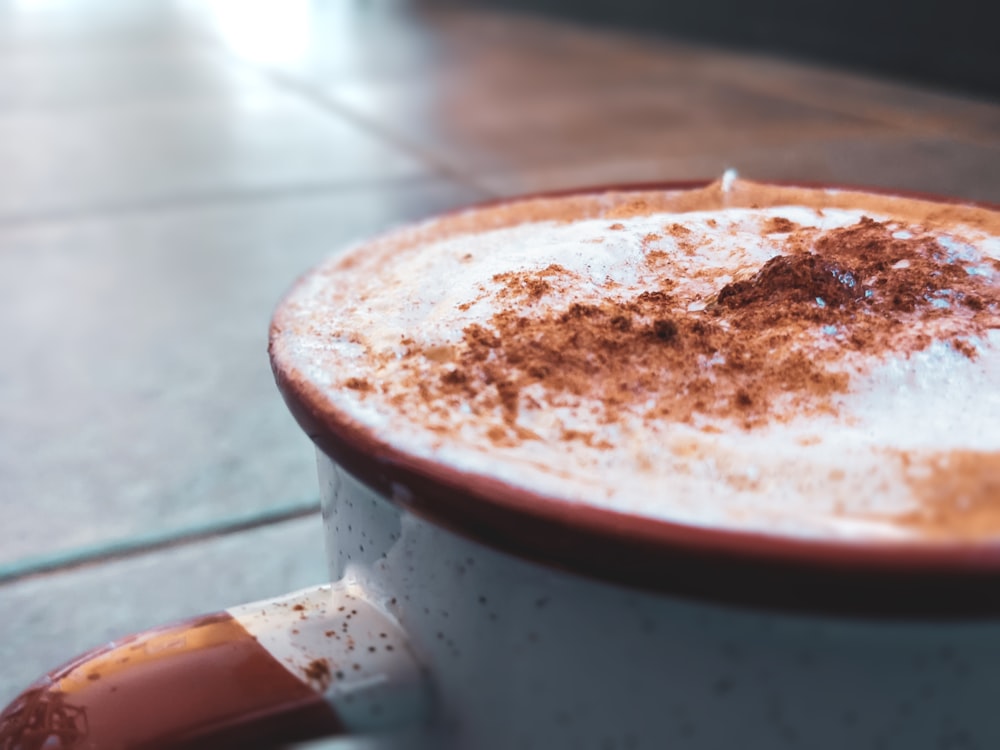 white ceramic mug with brown liquid