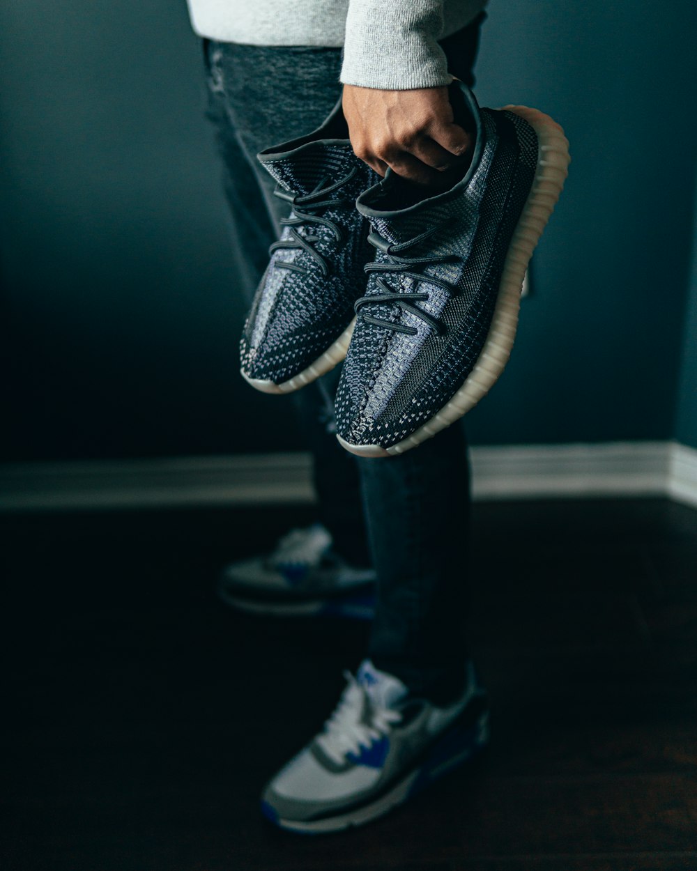 person in blue denim jeans and black and white nike athletic shoes