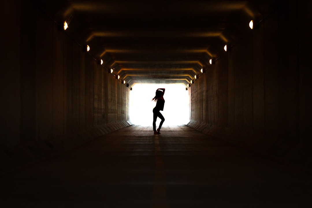 silhouette of person walking on tunnel photo – Free Tunnel Image on ... Silhouette Man Walking Tunnel