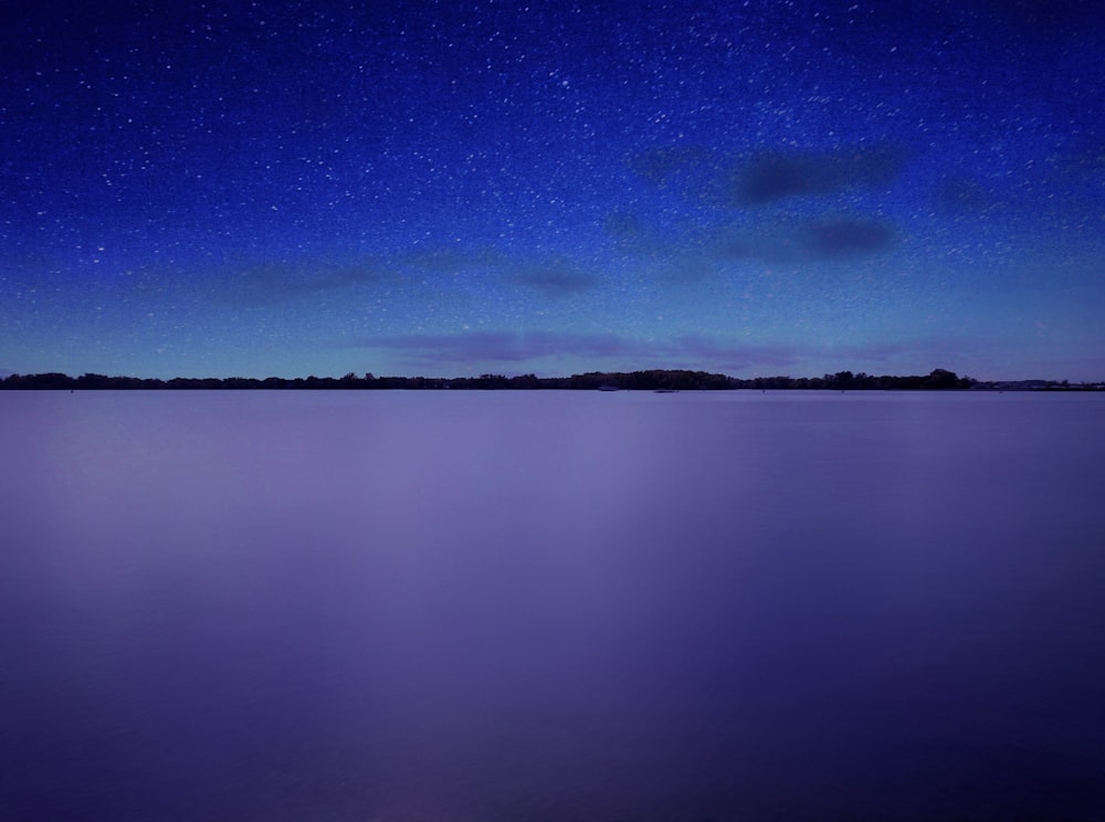 body of water under blue sky