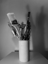 black and white brush in white ceramic mug
