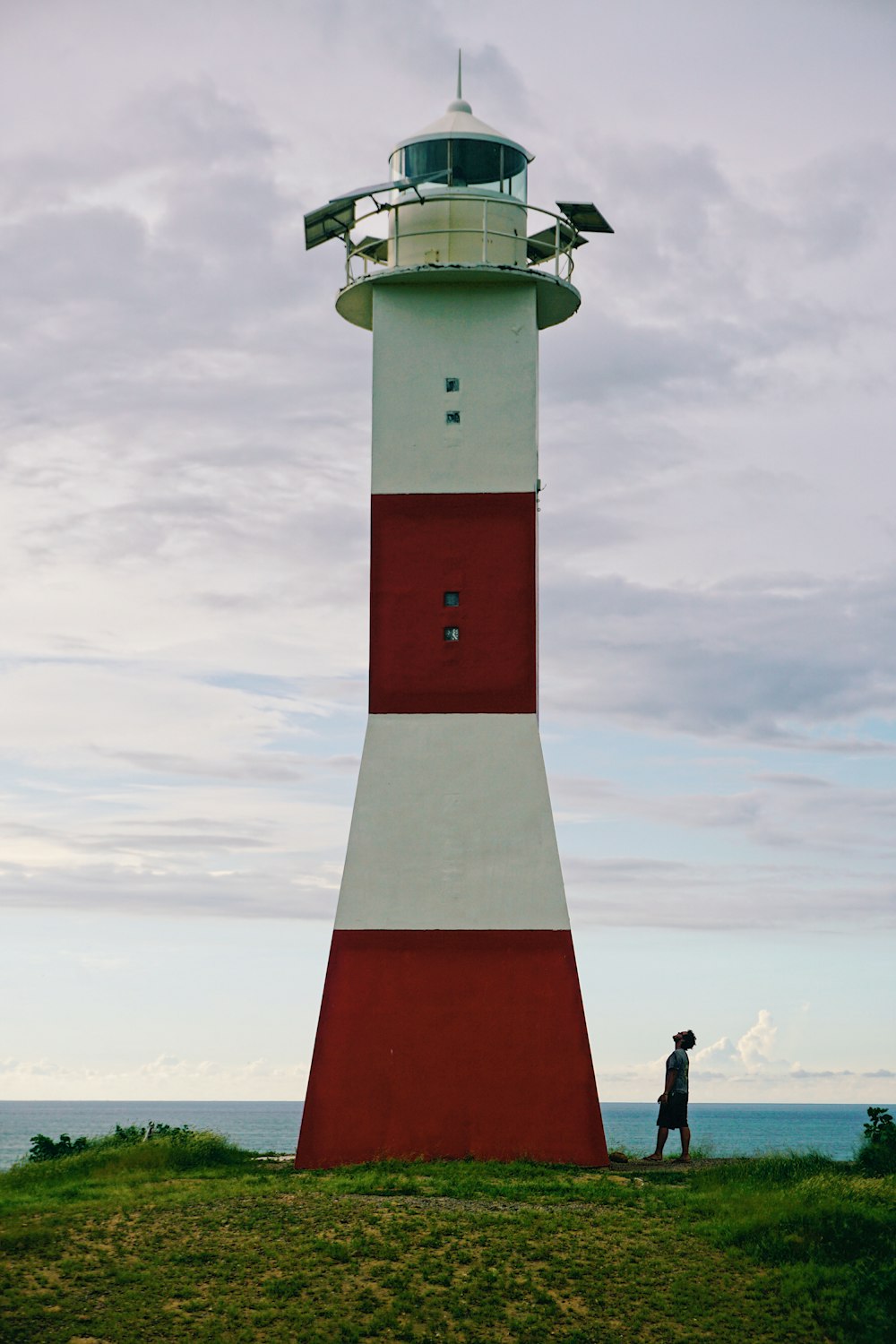 red and white lighthouse under cloudy sky during daytime