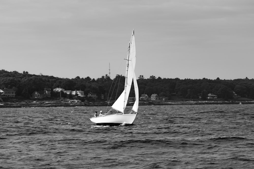 grayscale photo of sailboat on sea