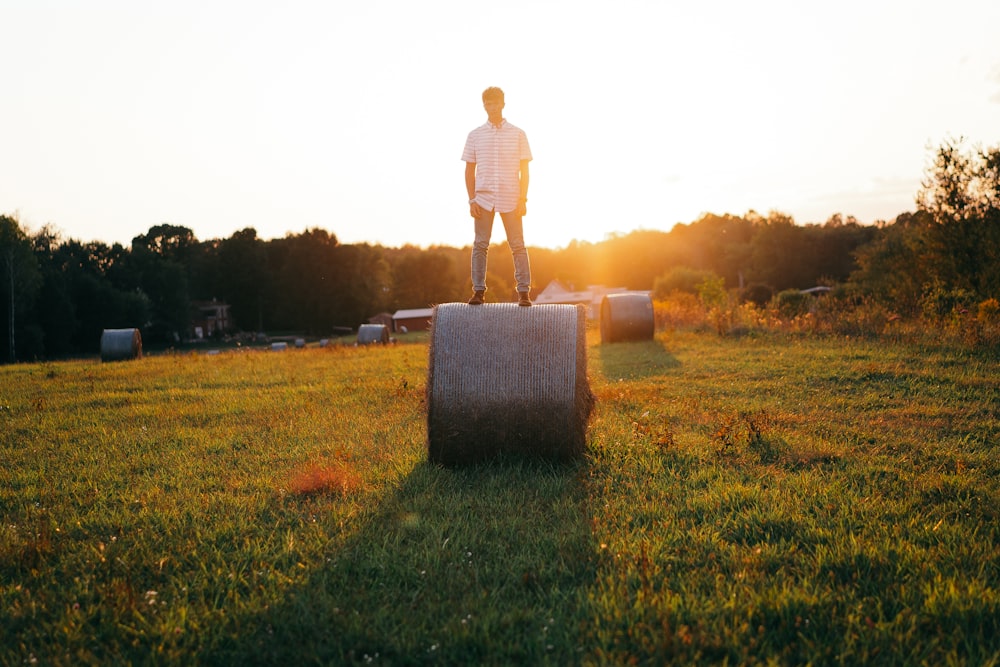 man in white shirt standing on brown grass field during daytime