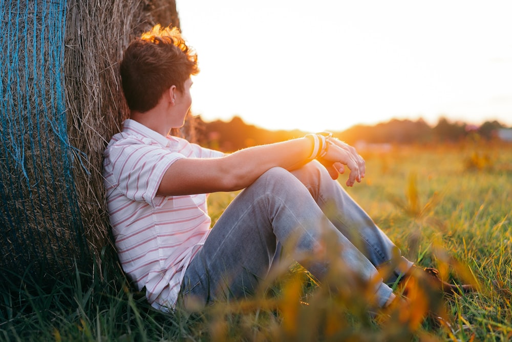 man and woman kissing on green grass field during daytime