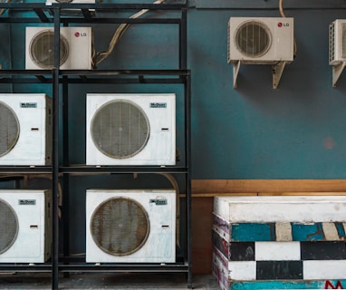 white and black box fan on brown wooden shelf