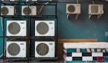 white and black box fan on brown wooden shelf