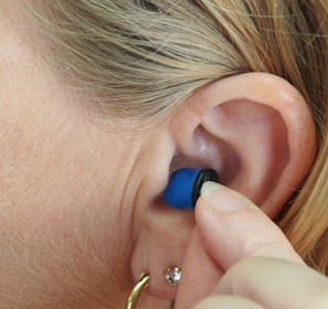 woman wearing blue stud earring