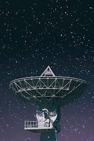 white satellite dish under starry night