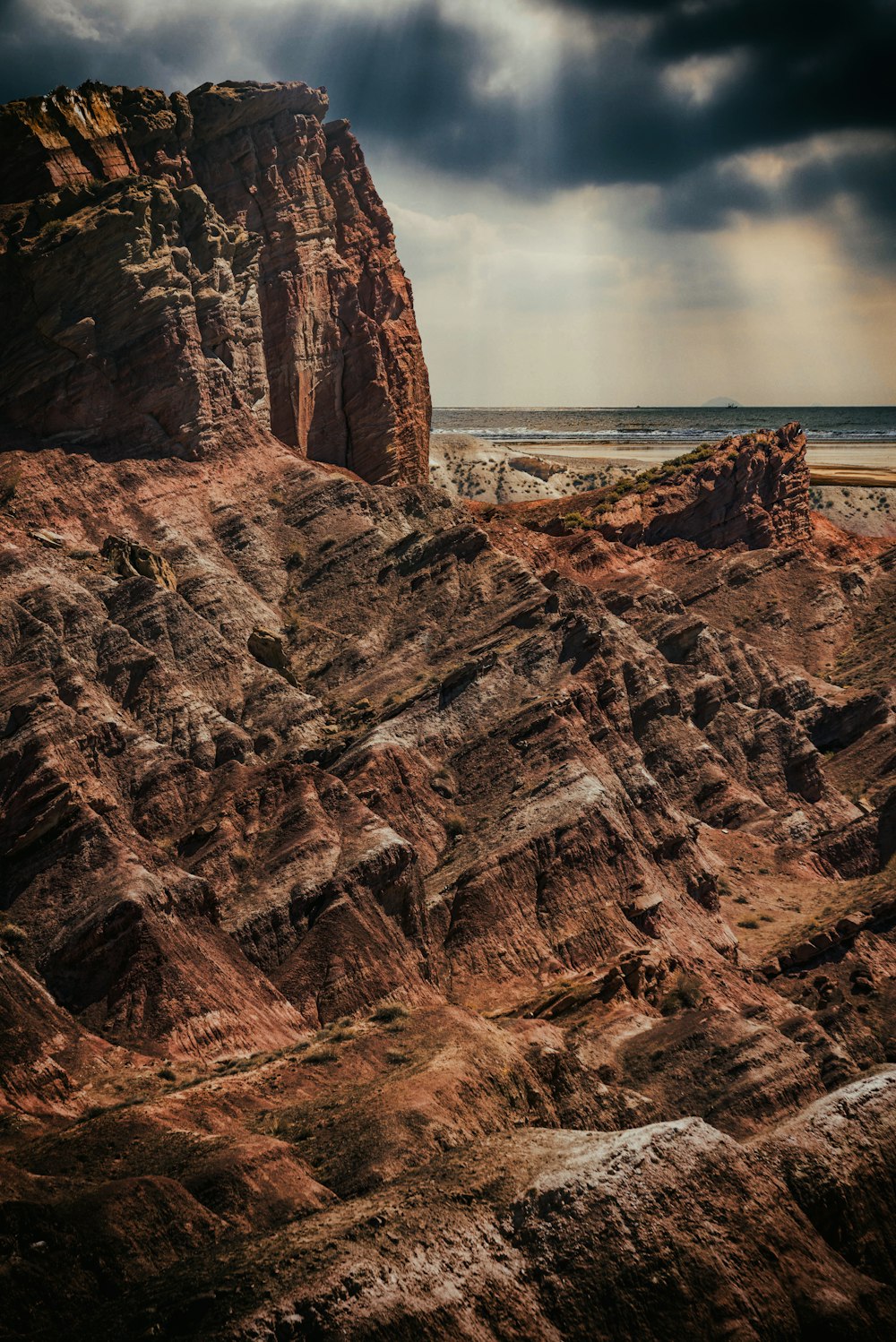 brown rock formation near body of water during daytime