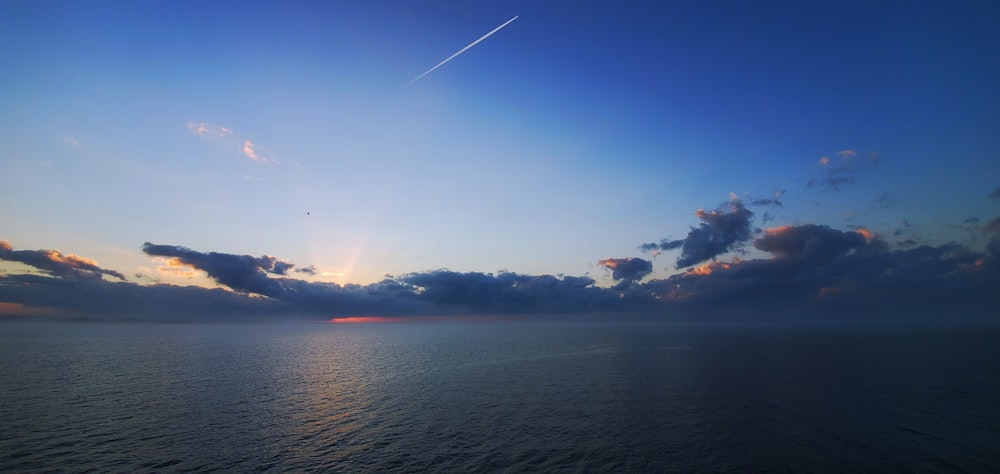 body of water under blue sky during daytime