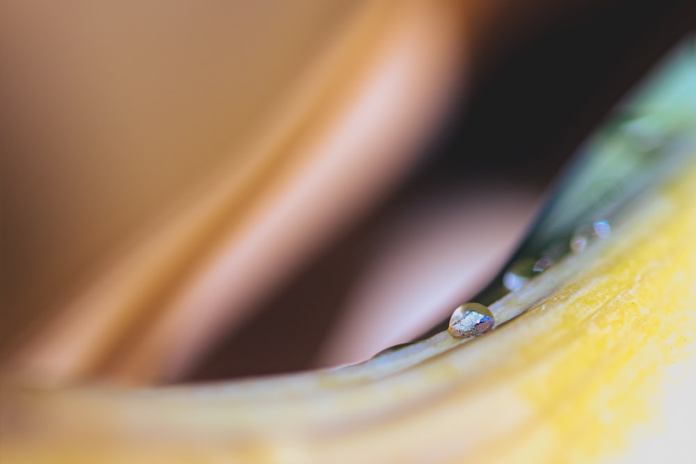 water droplets on yellow surface