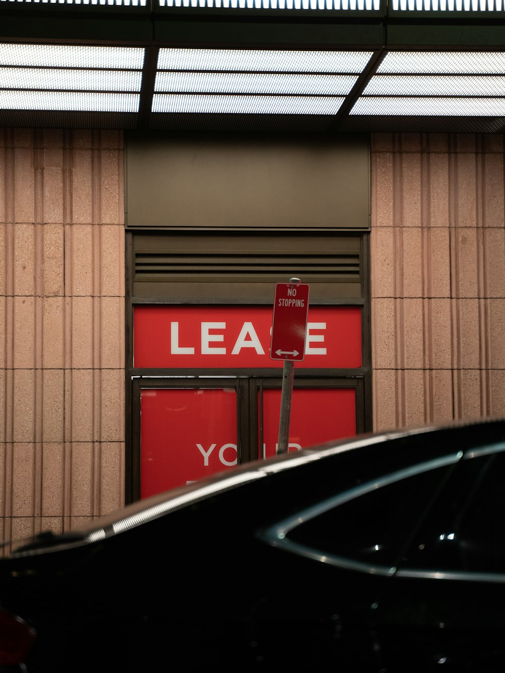 black car parked near red and white building