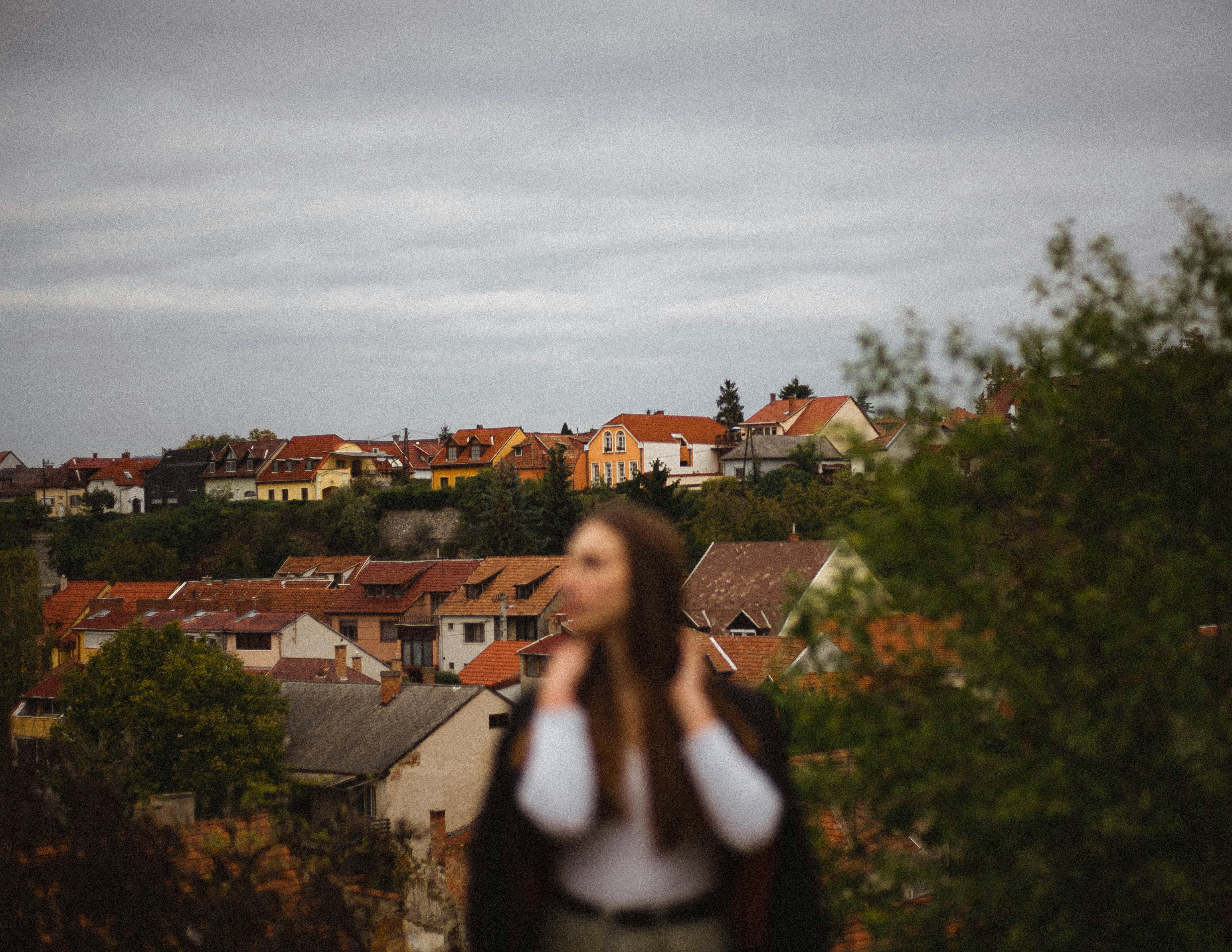 woman-in-white-and-black-dress-standing-on-top-of-the-building-during-daytime