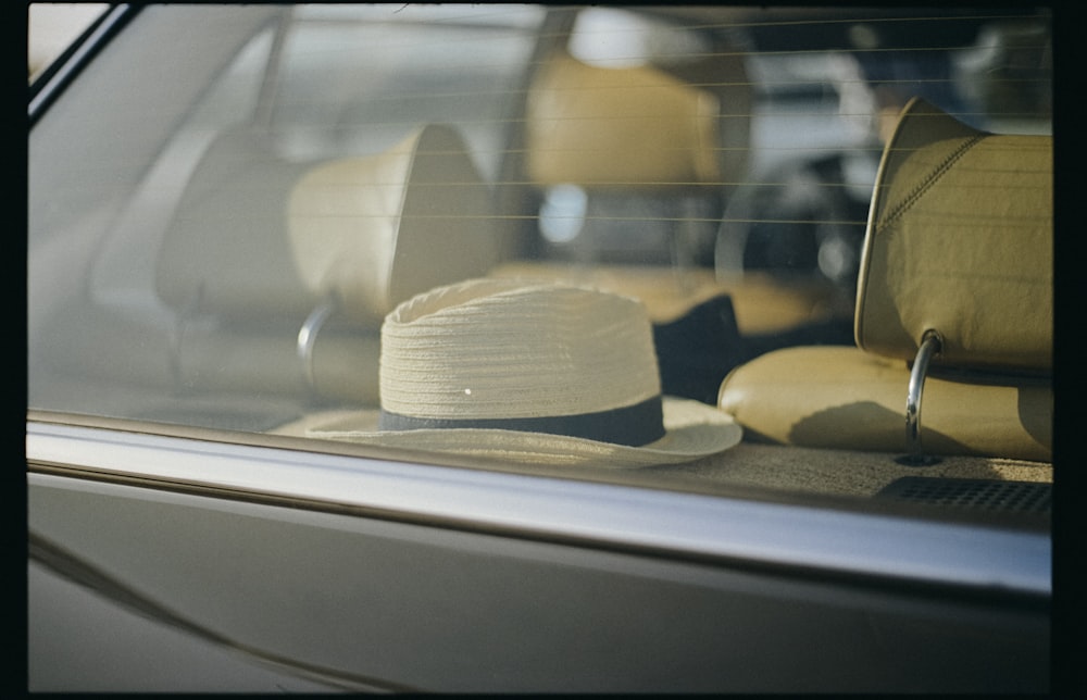 white and brown hat on white table