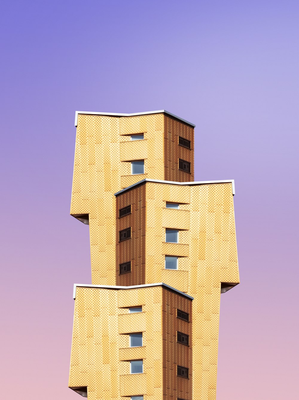 brown concrete building under blue sky during daytime