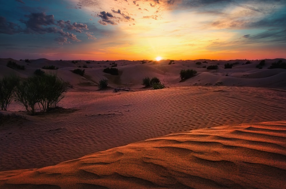 brown sand under cloudy sky during daytime