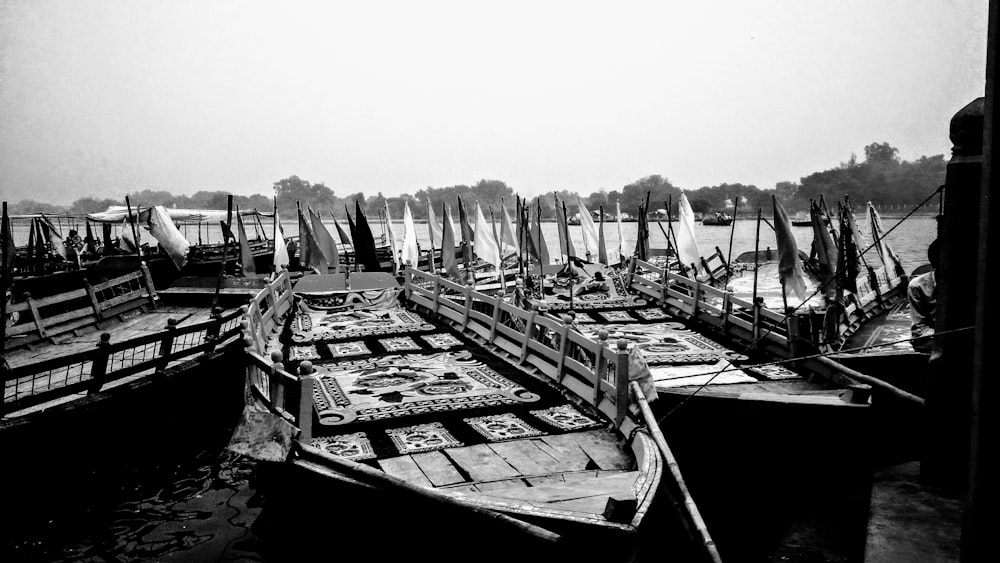 grayscale photo of boats on dock