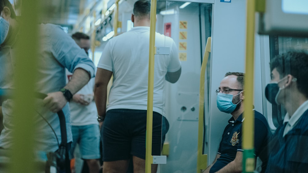 man in yellow crew neck t-shirt wearing white mask