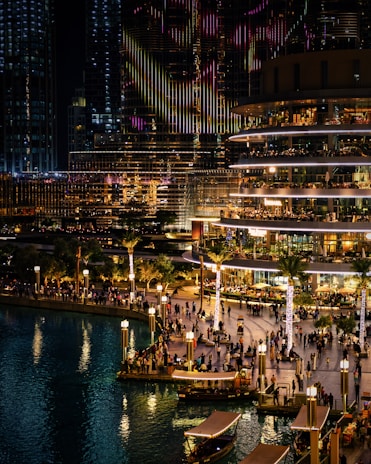 A vibrant view of Harburg's Binnenhafen with people walking along the promenade near modern buildings and historic warehouses.