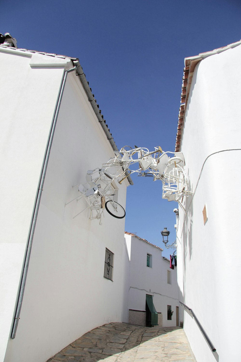 a white building with a bicycle hanging from it's side